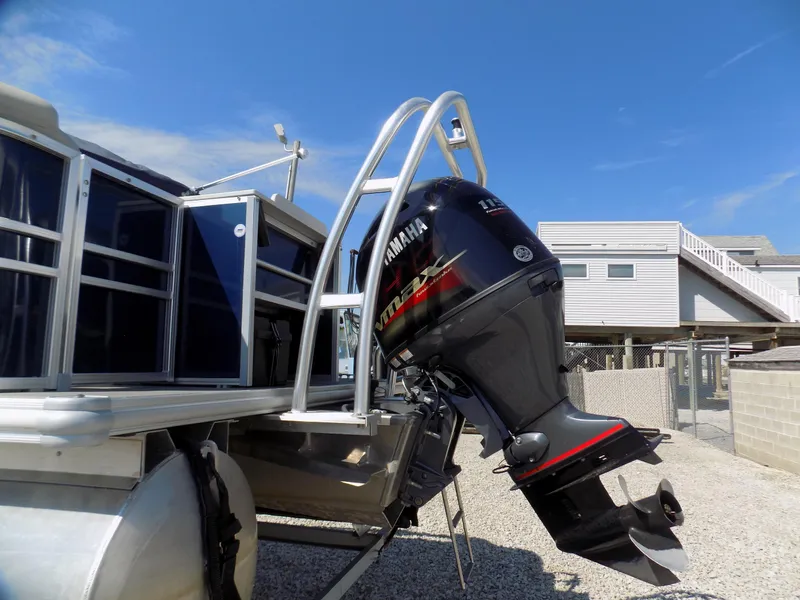 Slide: The Image of 2022 Sylvan Mirage Fish 8522 Party Fish boat with Yamaha outboard motor, docked under clear sky. - 4