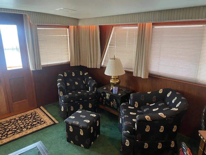 Slide: The Image of Interior of 1983 Hatteras 53 Motor Yacht with patterned chairs and elegant decor. - 10