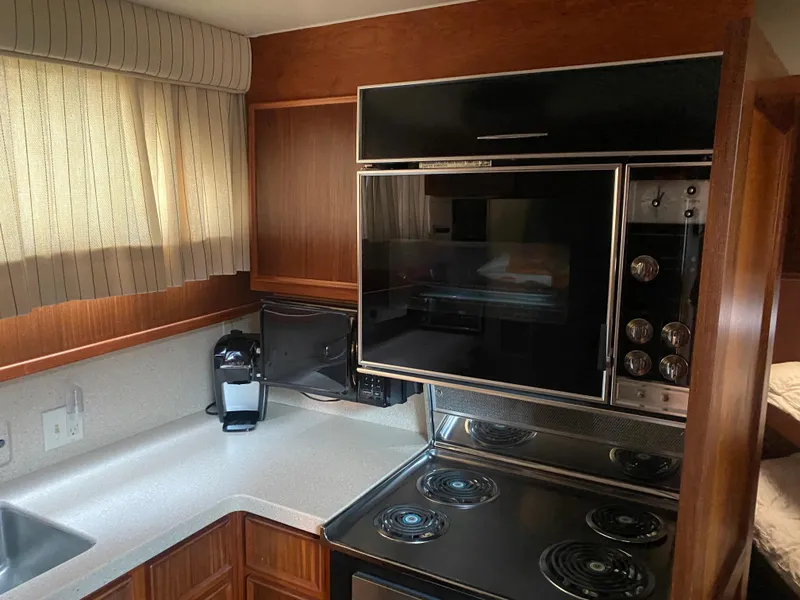Slide: The Image of 1983 Hatteras 53 Motor Yacht kitchen with stove, oven, and coffee maker. - 12
