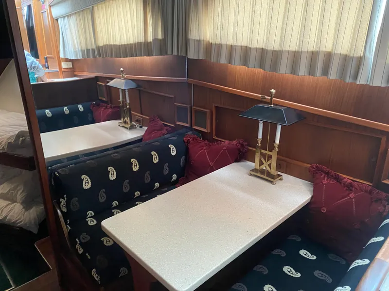 Slide: The Image of Interior of 1983 Hatteras 53 Motor Yacht with dining area and elegant decor. - 14
