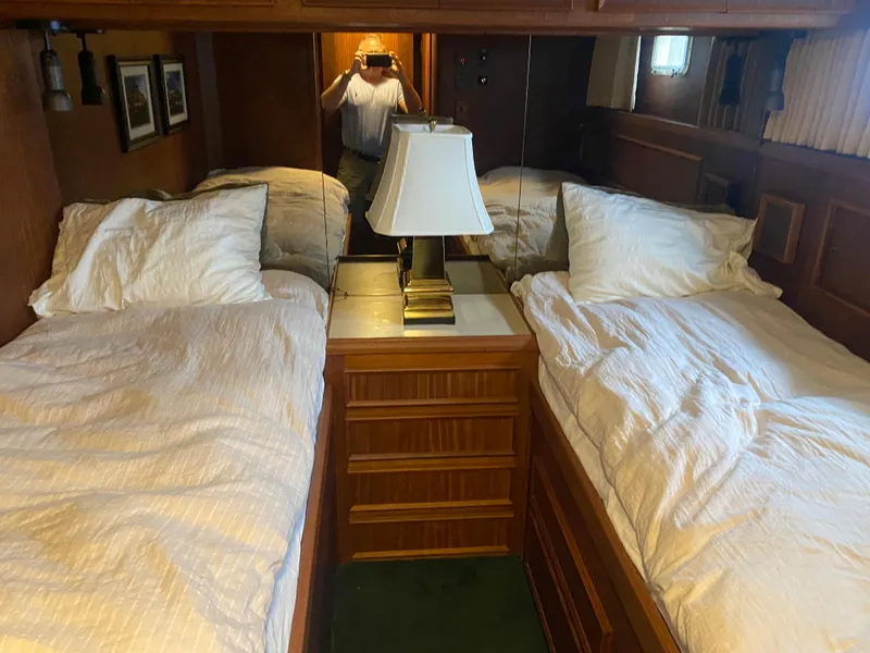 Slide: The Image of Interior of 1983 Hatteras 53 Motor Yacht with twin beds and wooden cabinetry. - 18