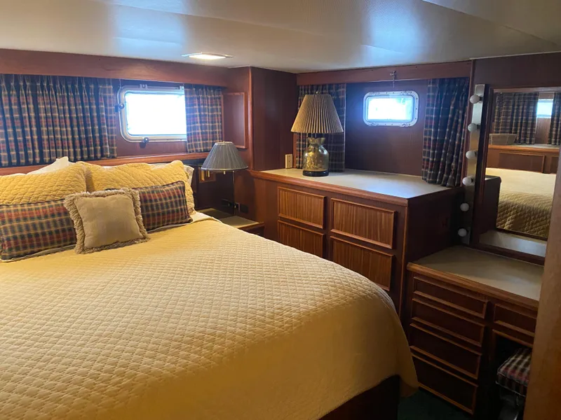 Slide: The Image of Cozy bedroom in 1983 Hatteras 53 Motor Yacht with wood furnishings and plaid curtains. - 20