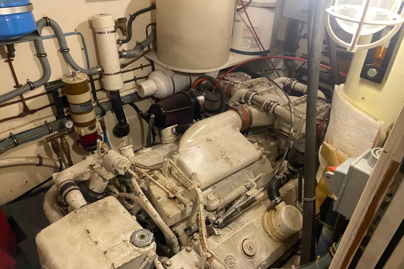 Slide: The Image of Engine room of 1983 Hatteras 53 Extended Deckhouse Motor Yacht, showcasing mechanical components. - 26
