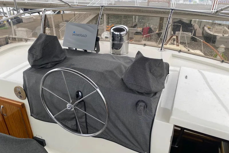 Slide: The Image of 1983 Hatteras 53 Extended Deckhouse Motor Yacht helm with covered controls and navigation equipment. - 27