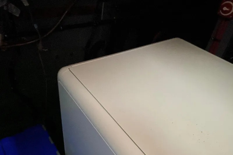 Slide: The Image of White appliance corner in dimly lit room, possibly on a 1983 Hatteras yacht. - 30