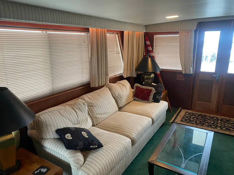 Slide: The Image of Interior of 1983 Hatteras 53 Motor Yacht with cozy seating and nautical decor. - 9