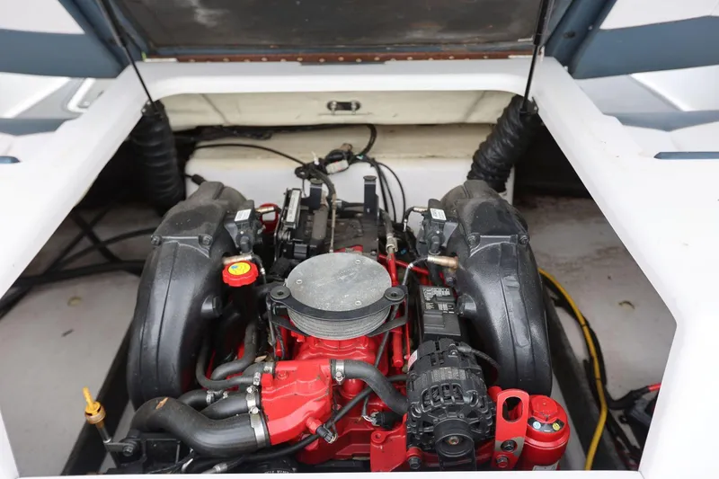 Slide: The Image of 2015 Four Winns H200 boat engine compartment with visible components and wiring. - 11