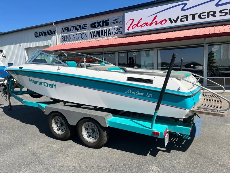 Slide: The Image of 1991 MasterCraft Maristar 210 boat on trailer outside Idaho Water Sports store. - 11