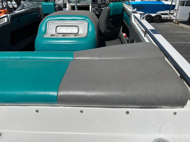 Slide: The Image of 1991 MasterCraft Maristar210 boat interior with teal and gray seating. - 13
