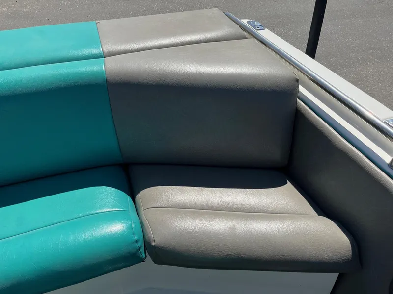Slide: The Image of 1991 MasterCraft Maristar210 boat interior with teal and gray seating. - 17