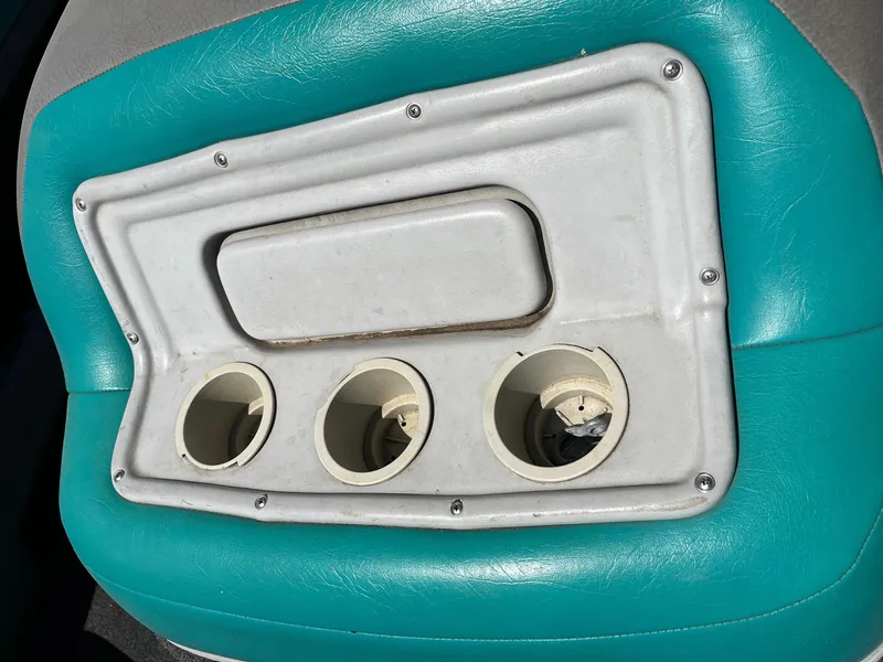 Slide: The Image of 1991 MasterCraft Maristar210 boat interior with teal upholstery and cup holders. - 19
