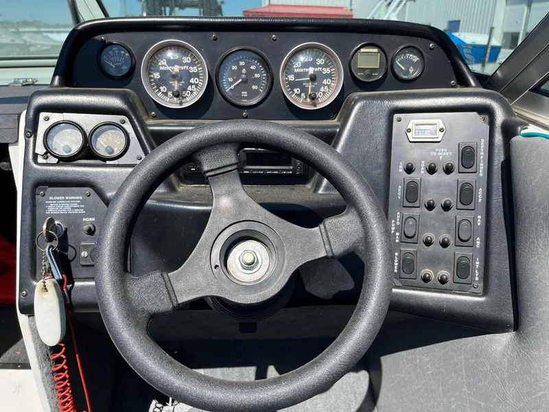 Slide: The Image of Dashboard of a 1991 MasterCraft Maristar210 boat with steering wheel and control panel. - 23