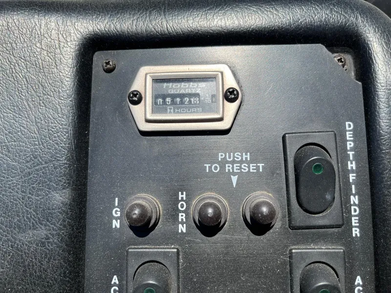 Slide: The Image of 1991 MasterCraft Maristar210 dashboard with hour meter and control switches. - 25
