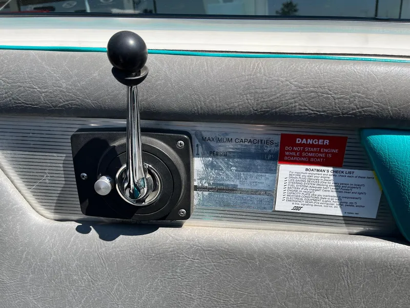 Slide: The Image of Throttle control and safety warnings on a 1991 MasterCraft Maristar210 boat dashboard. - 26