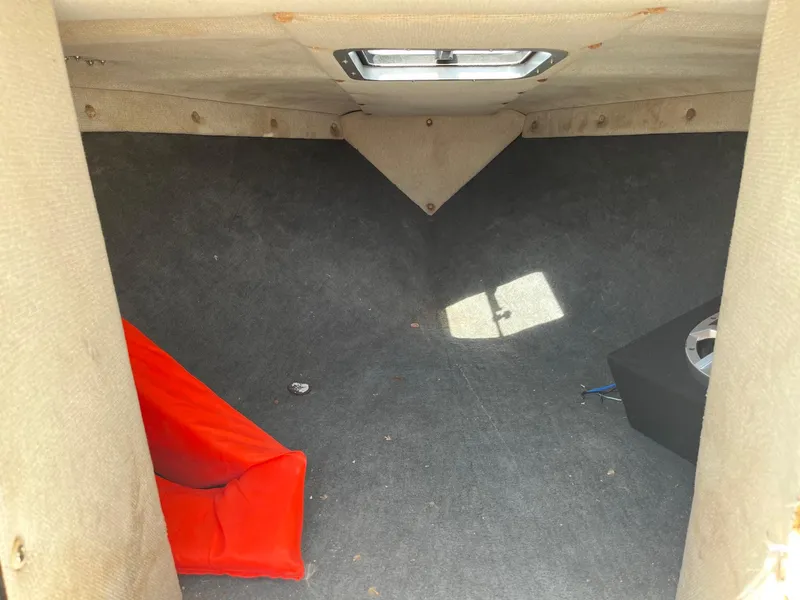 Slide: The Image of Interior of 1991 MasterCraft Maristar210 boat with red cushion and speaker. - 29