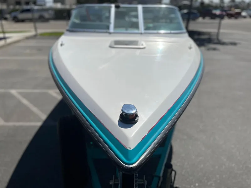 Slide: The Image of 1991 MasterCraft Maristar210 boat, front view, parked outdoors. - 5