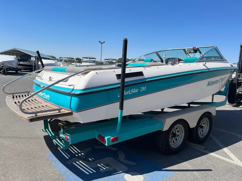 Slide: The Image of 1991 MasterCraft Maristar 210 boat on trailer in parking lot, sunny day. - 8