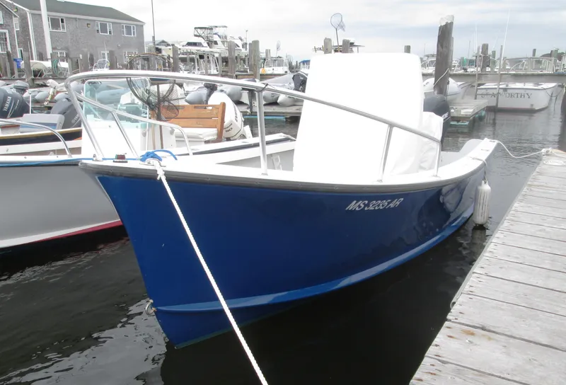 Slide: The Image of 1975 Tripp Center Console boat docked at a marina. - 0