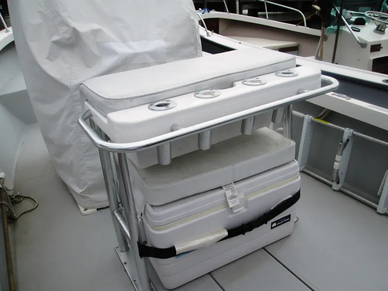 Slide: The Image of 1975 Tripp Center Console boat with cushioned seating and storage area. - 2