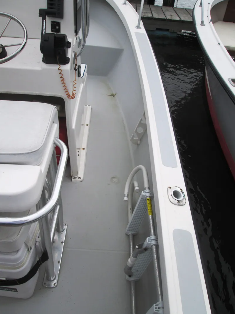 Slide: The Image of 1975 Tripp Center Console boat interior with seating and steering wheel. - 6
