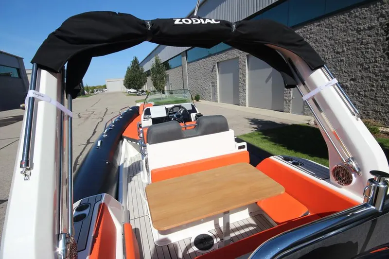Slide: The Image of 2022 Zodiac Medline 7.5 NEO boat with seating and table, docked outdoors. - 10