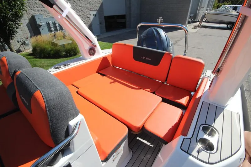 Slide: The Image of 2022 Zodiac Medline 7.5 NEO boat with orange seating and 300hp engine. - 14