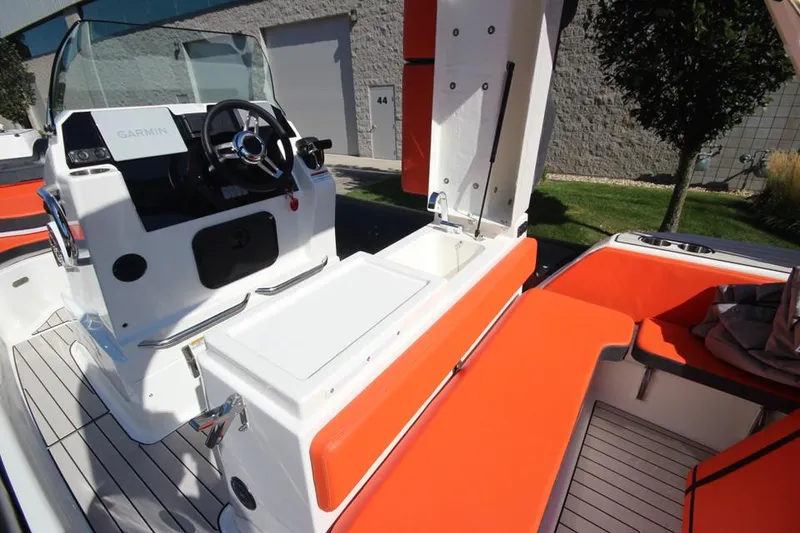 Slide: The Image of 2022 Zodiac Medline 7.5 NEO boat interior with orange seating and modern controls. - 16