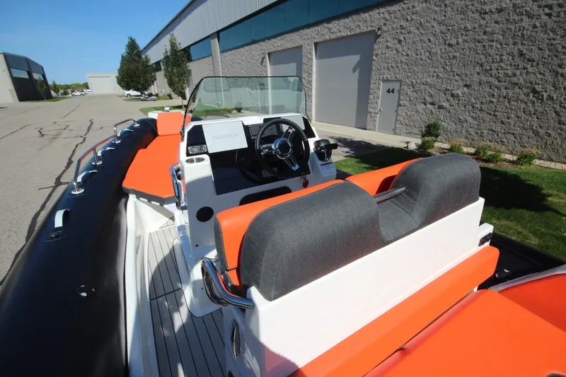 Slide: The Image of 2022 Zodiac Medline 7.5 NEO boat with orange seating and modern dashboard. - 18
