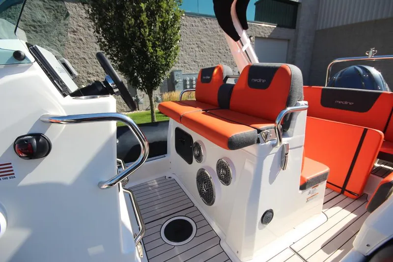 Slide: The Image of 2022 Zodiac Medline 7.5 NEO boat interior with orange seating and modern design. - 19