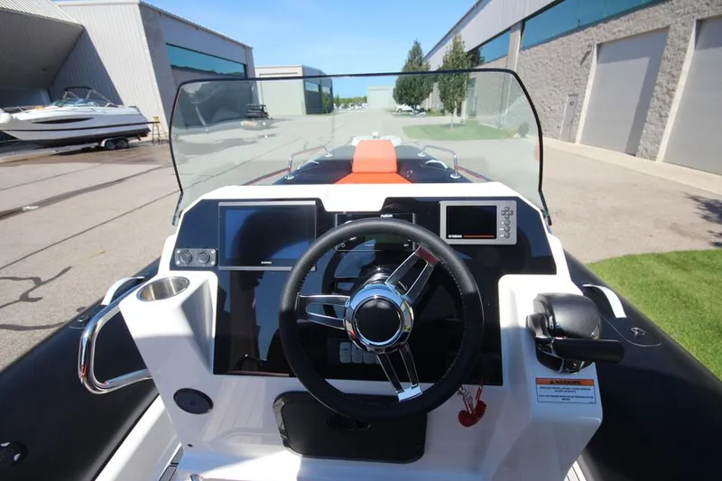 Slide: The Image of 2022 Zodiac Medline 7.5 NEO boat dashboard with steering wheel and controls. - 20
