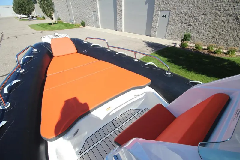 Slide: The Image of 2022 Zodiac Medline 7.5 NEO boat with orange seating, docked outdoors. - 24