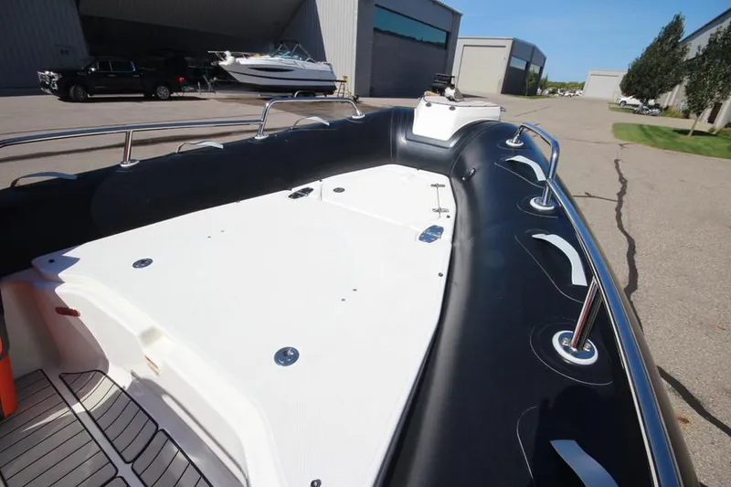 Slide: The Image of 2022 Zodiac Medline 7.5 NEO boat, spacious deck, parked outdoors. - 26