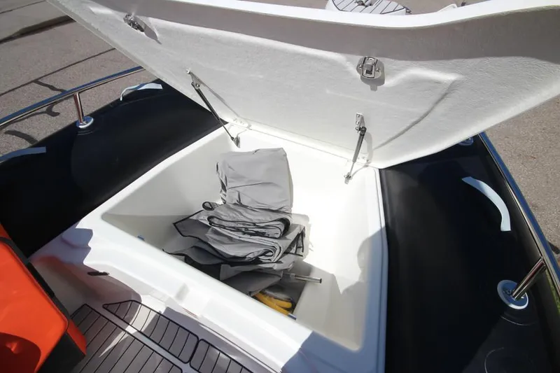 Slide: The Image of Open storage compartment on 2022 Zodiac Medline 7.5 NEO boat, showing interior space. - 27