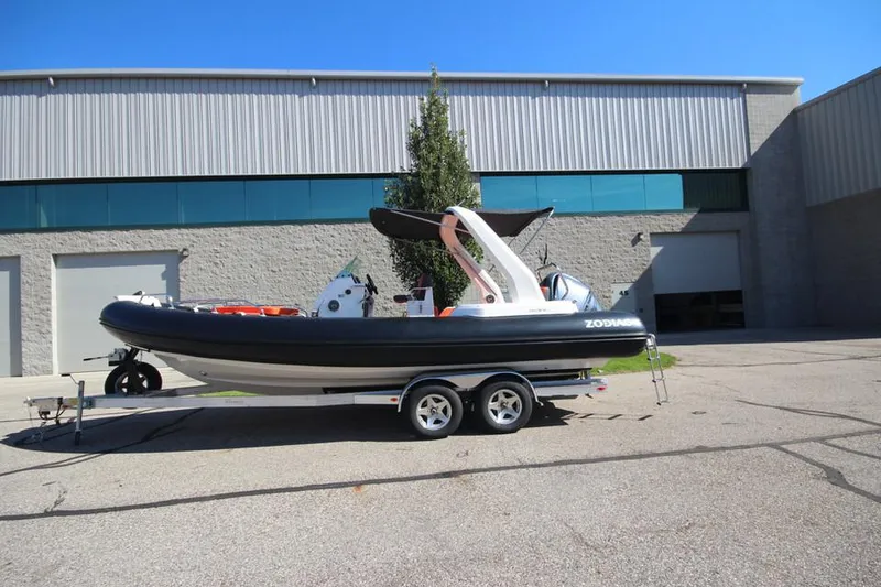 Slide: The Image of 2022 Zodiac Medline 7.5 NEO 300hp boat on trailer, parked outside warehouse. - 30