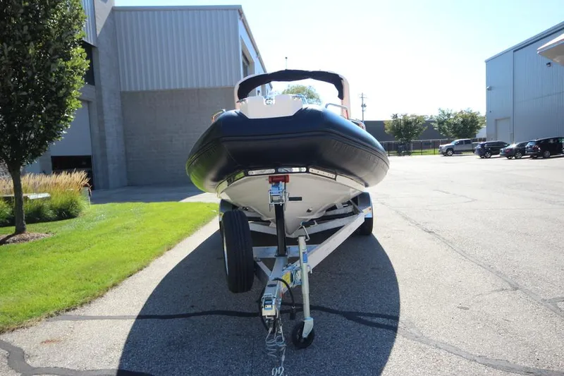 Slide: The Image of 2022 Zodiac Medline 7.5 NEO 300hp boat on trailer, parked outdoors. - 4