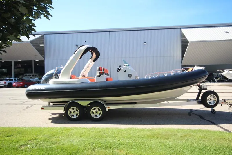 Slide: The Image of 2022 Zodiac Medline 7.5 NEO 300hp boat on trailer outside a warehouse. - 6