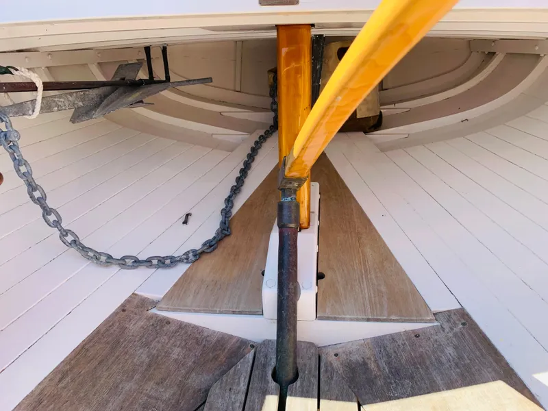 Slide: The Image of Interior of a 1914 Buzzards Bay 25 sailboat showing anchor chain and wooden deck. - 10