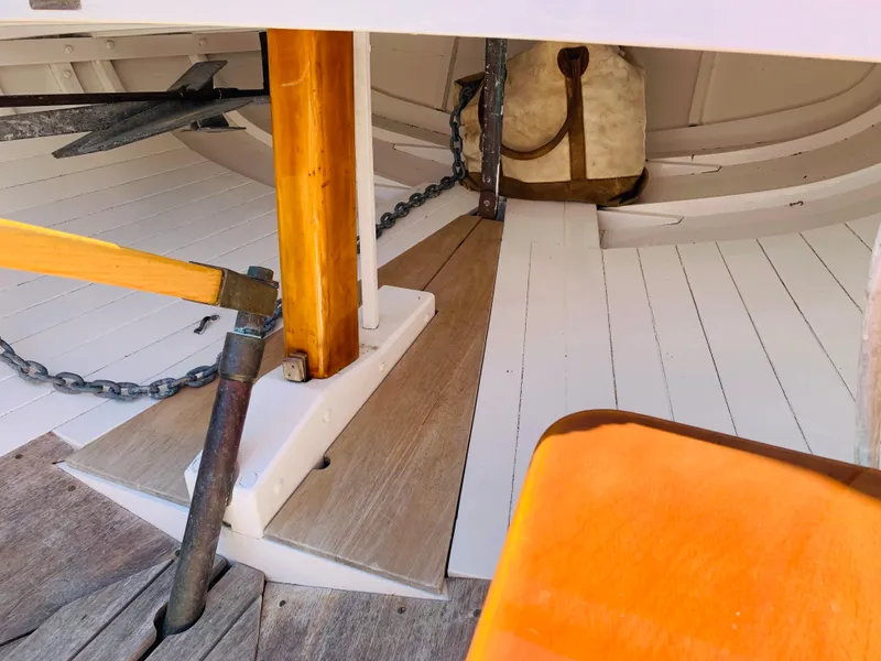 Slide: The Image of Interior of a 1914 Buzzards Bay 25 sailboat showing anchor and wooden flooring. - 11