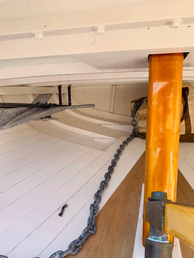 Slide: The Image of Interior of a 1914 Buzzards Bay 25 sailboat showing anchor chain and wooden mast. - 13