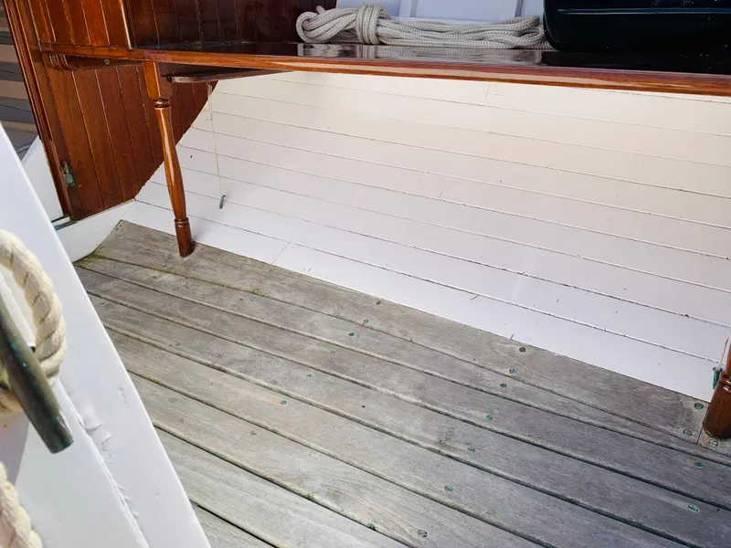 Slide: The Image of Interior of a 1914 Buzzards Bay 25 sailboat with wooden flooring and rope. - 15