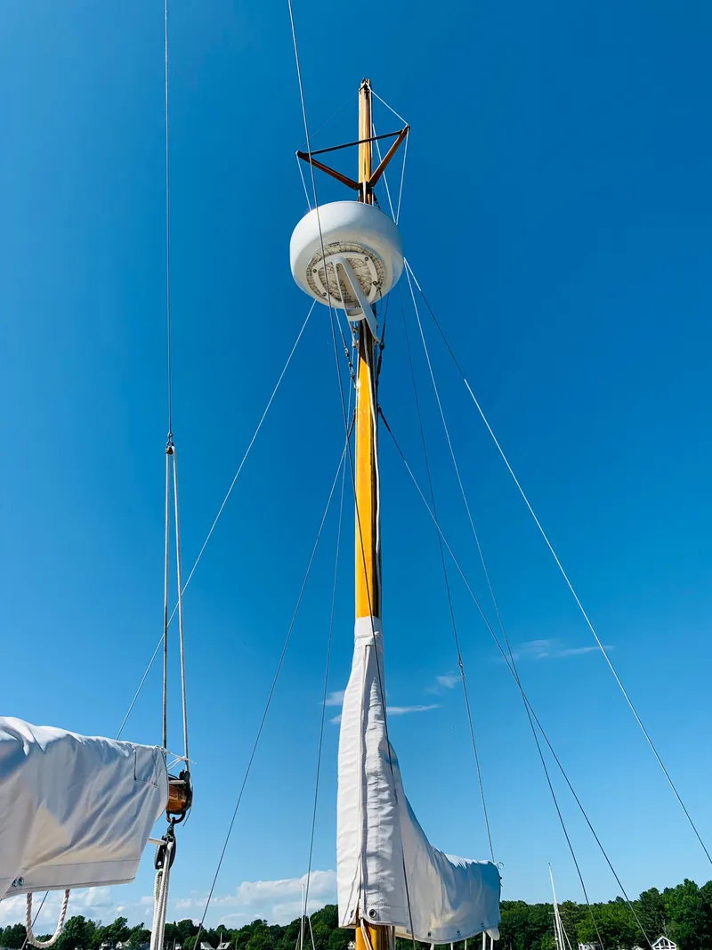 Slide: The Image of Buzzards Bay 25 sailboat mast against clear blue sky, 1914 model. - 17