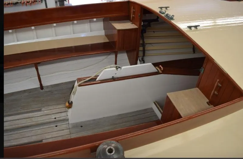 Slide: The Image of Interior of a 1914 Buzzards Bay 25 sailboat with wooden details and seating. - 19