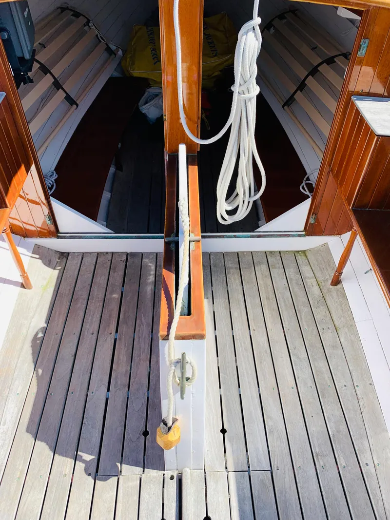 Slide: The Image of Interior of a 1914 Buzzards Bay 25 sailboat with wooden flooring and rope. - 7