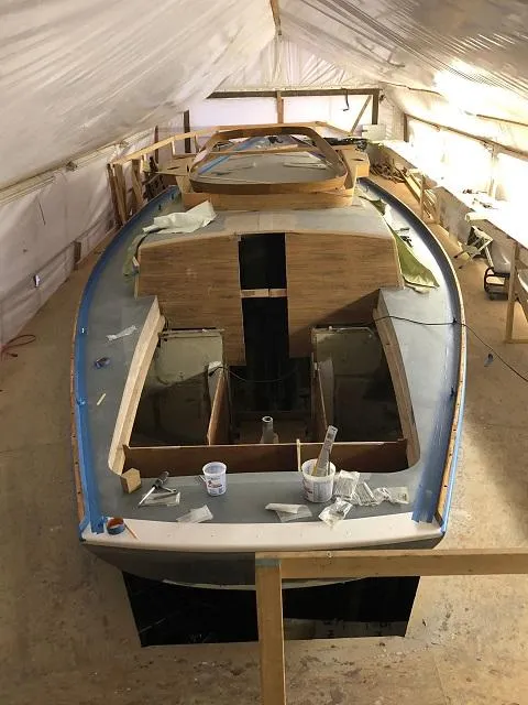 Slide: The Image of 1971 Little Harbor sailboat under restoration in a workshop setting. - 2
