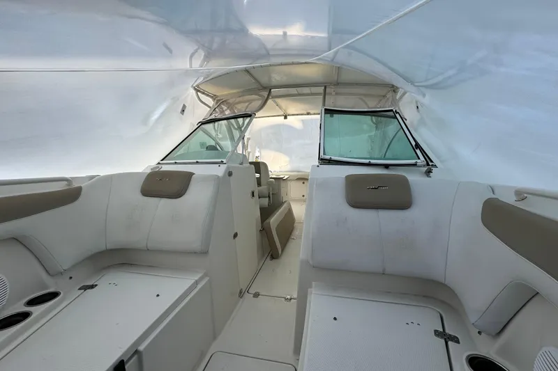 Slide: The Image of 2015 Sailfish 275 DC boat interior with seating and windshield under a canopy. - 11