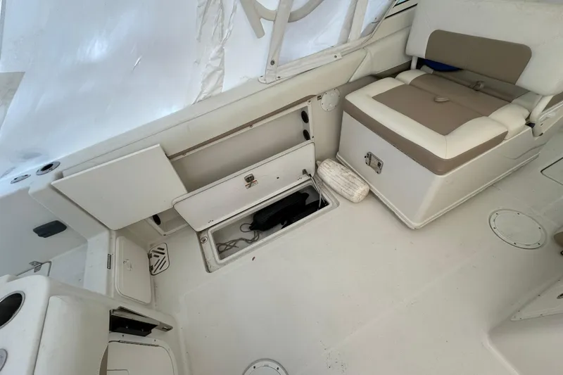 Slide: The Image of 2015 Sailfish 275 DC boat interior with storage compartments and seating. - 16