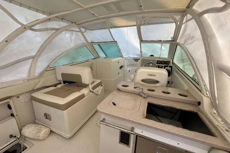 Slide: The Image of Interior of a 2015 Sailfish 275 DC boat with seating and helm station. - 17