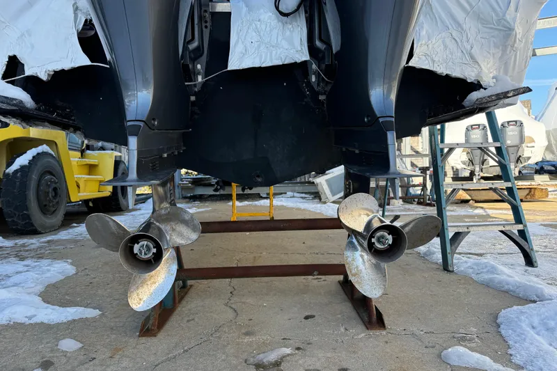 Slide: The Image of 2015 Sailfish 275 DC boat with dual outboard motors on a snowy dock. - 18