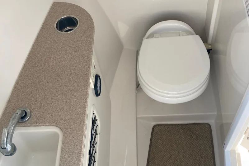 Slide: The Image of Interior of 2015 Sailfish 275 DC with toilet and sink. - 8