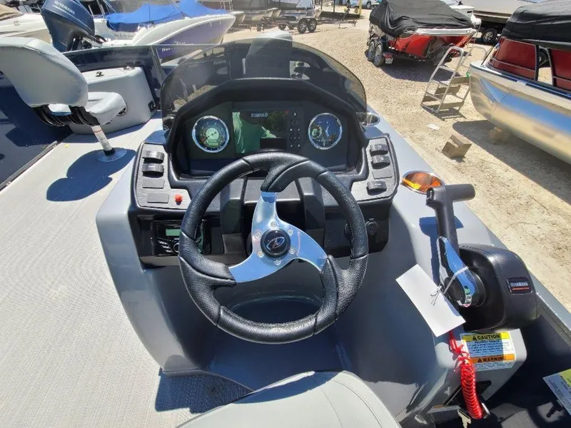 Slide: The Image of 2022 Veranda VF22F4 Deluxe Tri-Toon boat dashboard with steering wheel and control panel. - 5